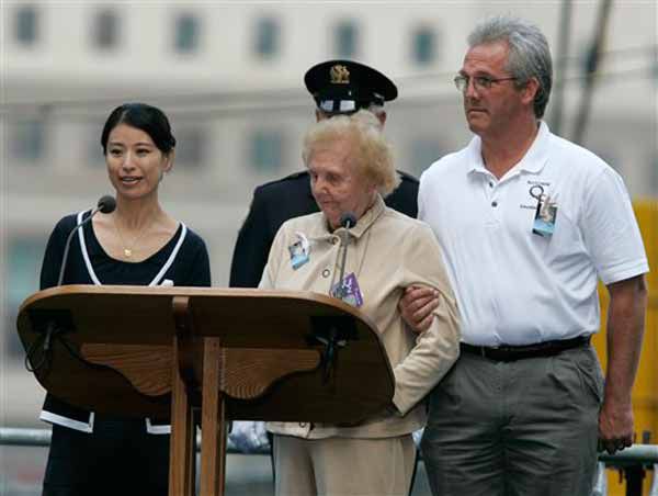 Mariko Koresada, of Japan, left, reads the names of the victims of the Sept. 11, 2001 attacks with Jean Hoffman, center. This year, the victims' names were read by family members a person from one of the 115 countries victims hailed from.